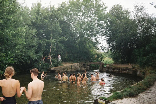 Group of swimmers from London wild swimming at the Compton Lock near Winchester