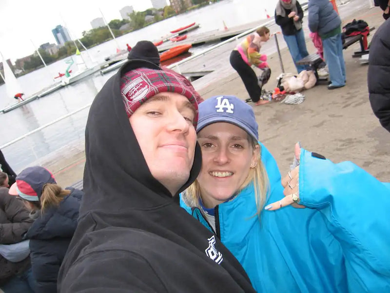 Two people taking a selfie by London's West Reservoir Centre with paddle boats in the background