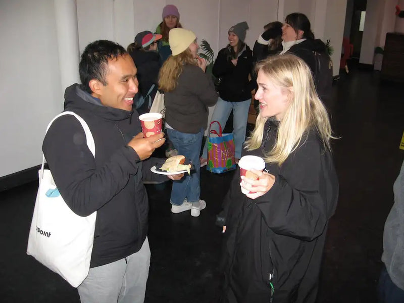 Two people standing and eating after swim club in London
