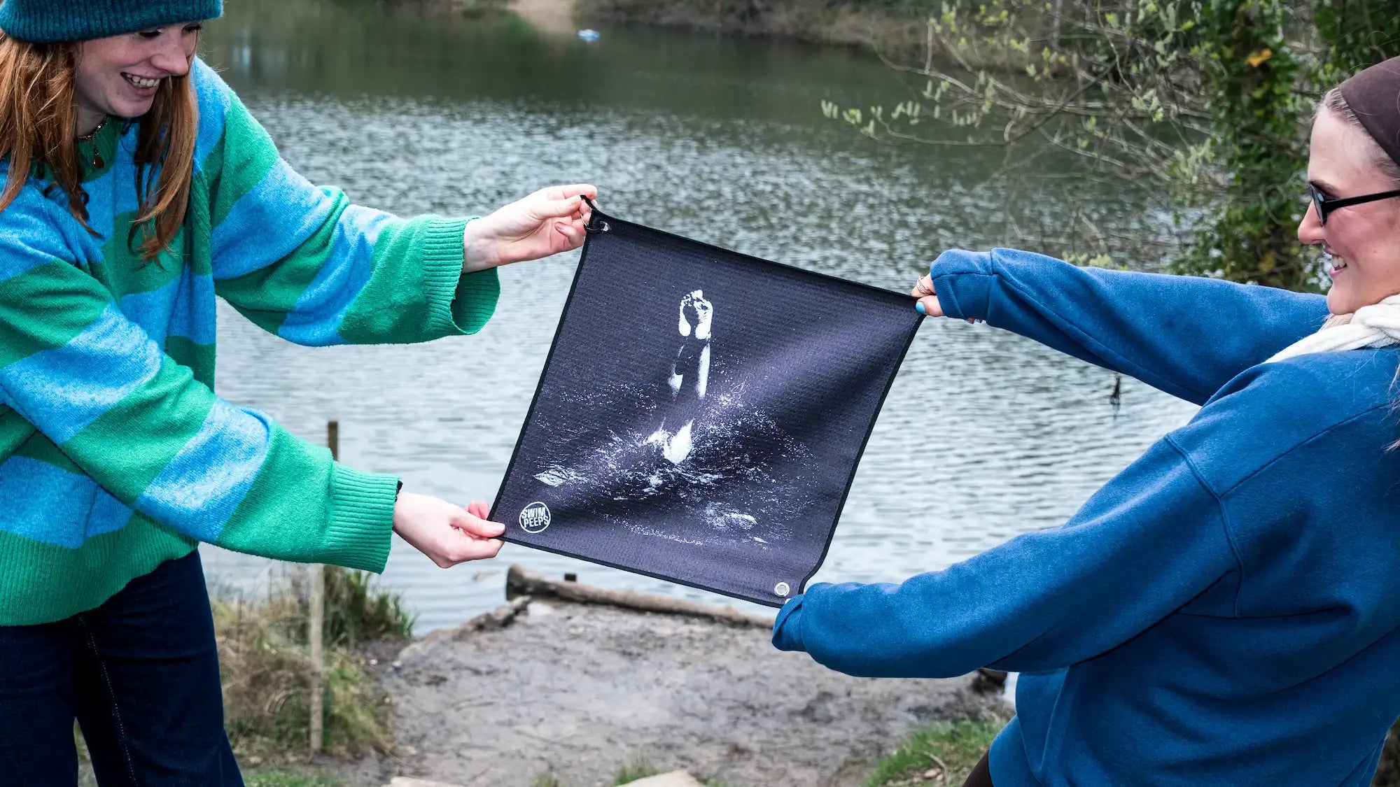 Two young urban swimmers holding a Swim Peeps Swim Changing Mat