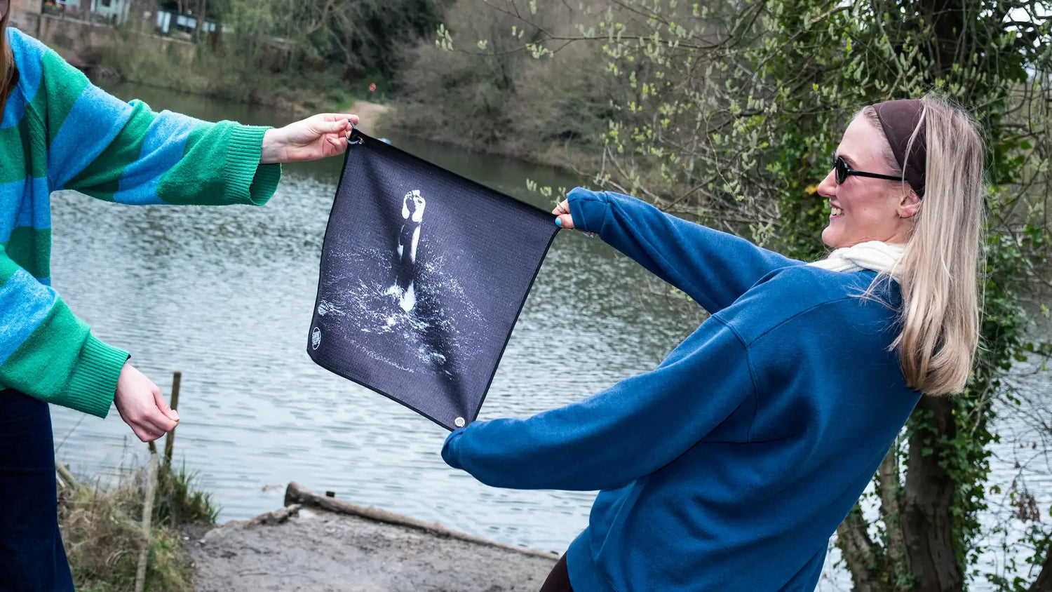 Two urban swimmers holding the Swim Peeps Dry Step Swim Changing Mat