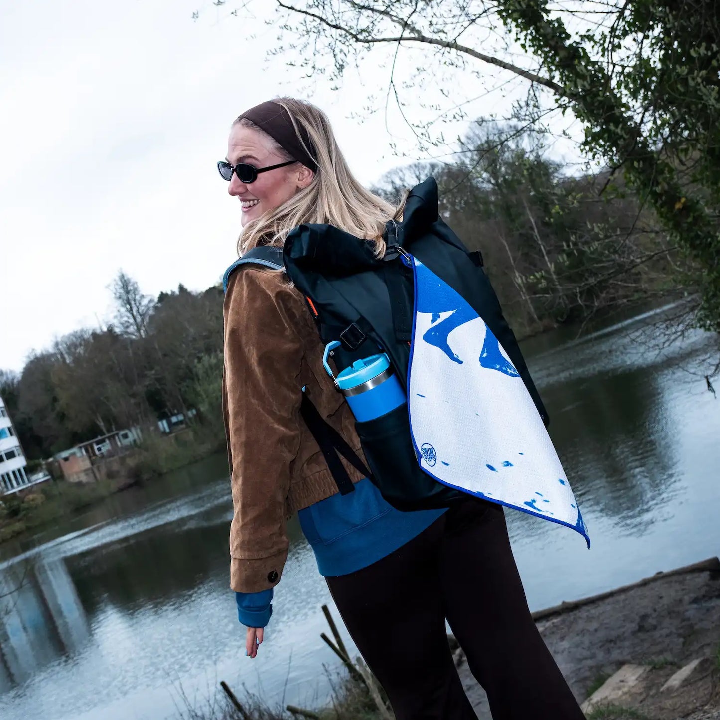 Urban swimmer with the Swim Peeps Dry Step Swim Changing Mat clipped to their swim bag