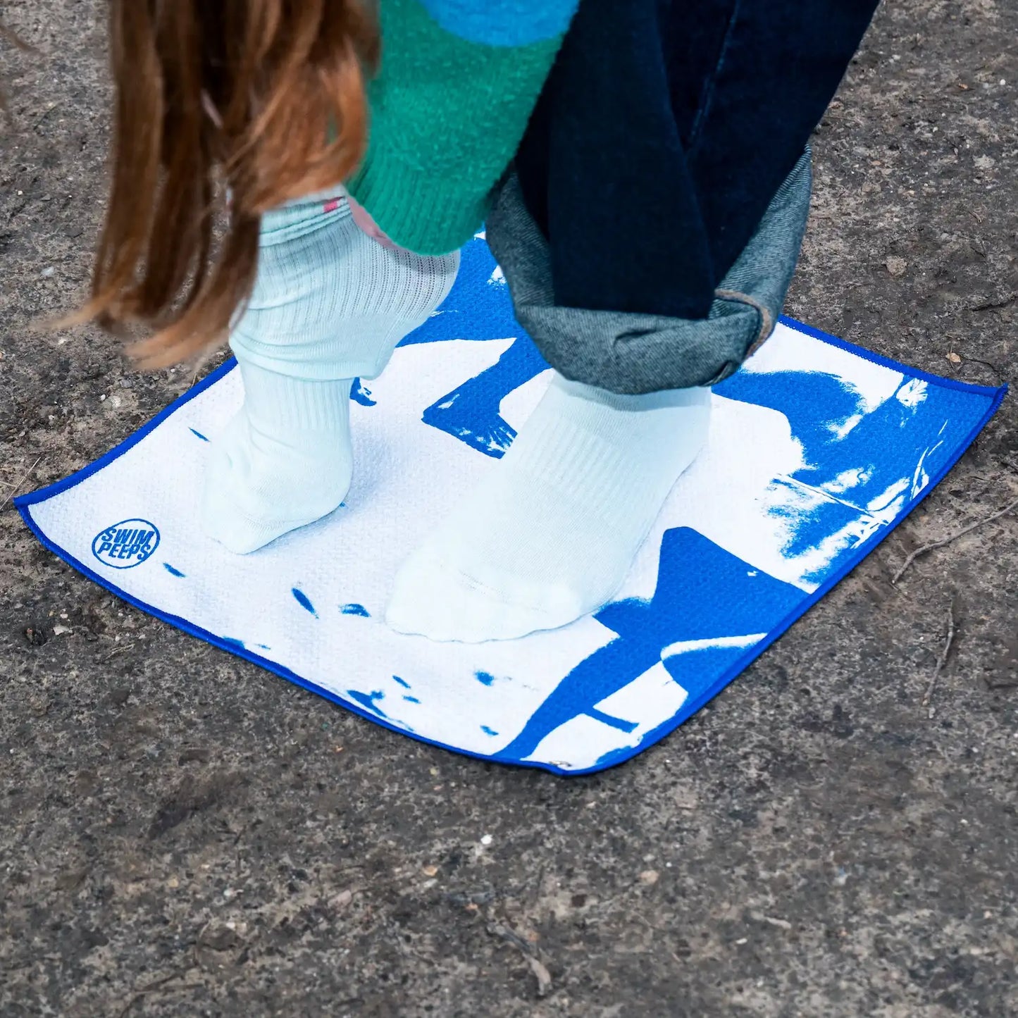 Swim Peeps Dry Step Swim Changing Mat being used blue and white colourway